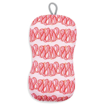 A textured sponge scrubber with a white body, covered in horizontal rows of red scribbled patterns, and featuring a gray hanging loop at the top, shown against a plain white background.