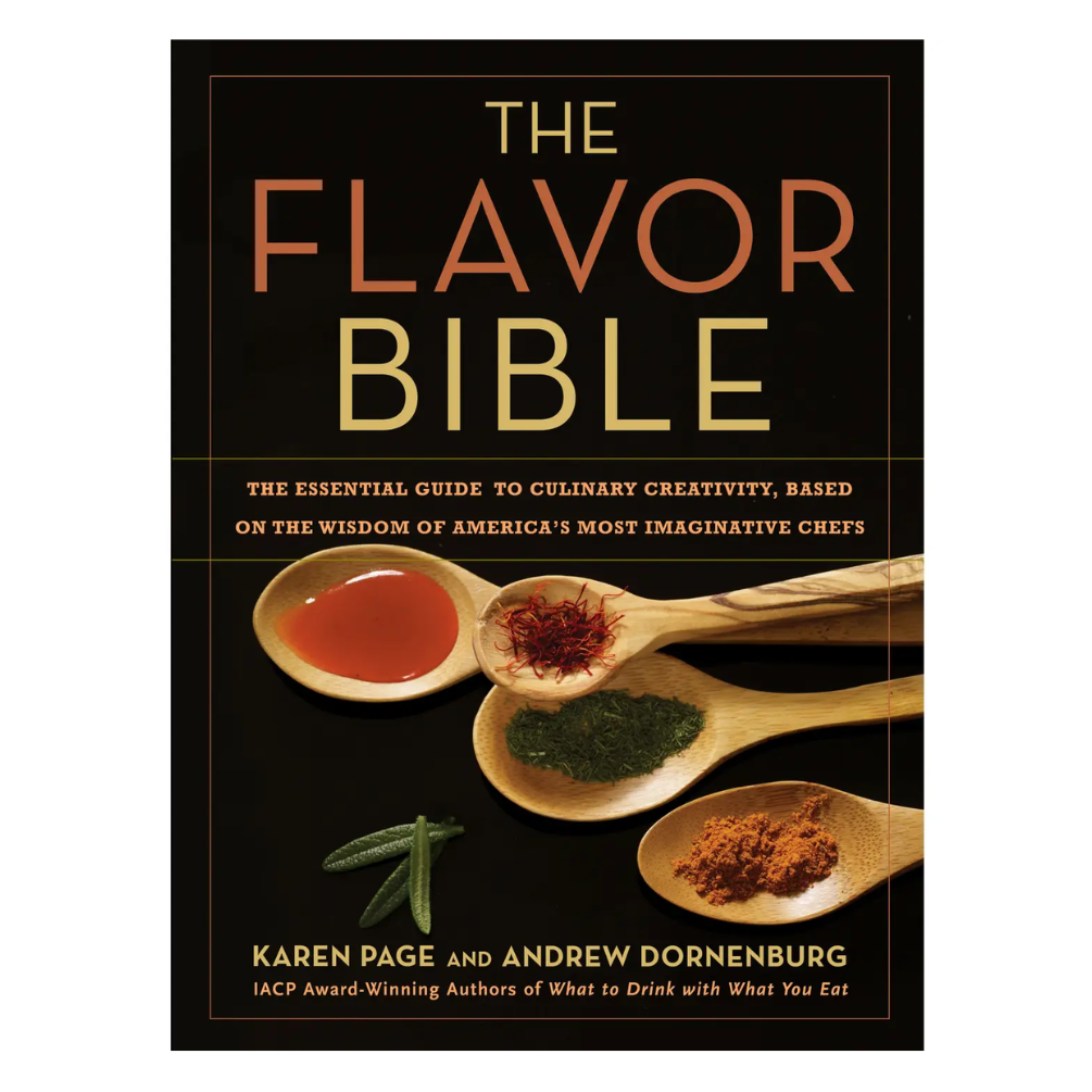 The Flavor Bible book cover by Karen Page and Andrew Dornenburg, featuring a black background with gold and orange typography and four wooden spoons holding spices and liquids on the front.