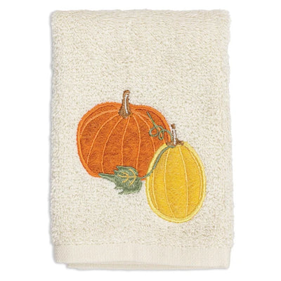 Beige towel with embroidered pumpkins on a white background