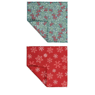 Two fabric swatches, one with a green background and red floral pattern, the other with a red background and white snowflake pattern.