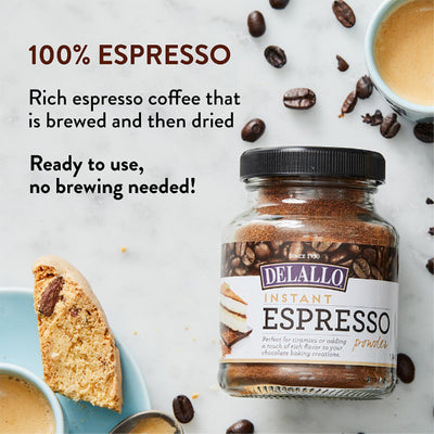 Jar of Delallo Instant Espresso powder with coffee beans and a biscotti on a light background