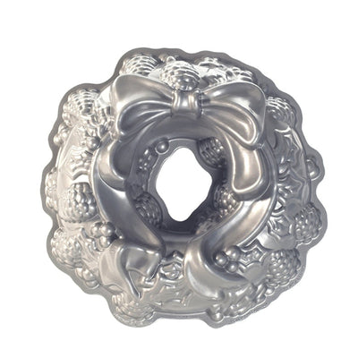 Decorative silver wreath-shaped object with a bow on a white background