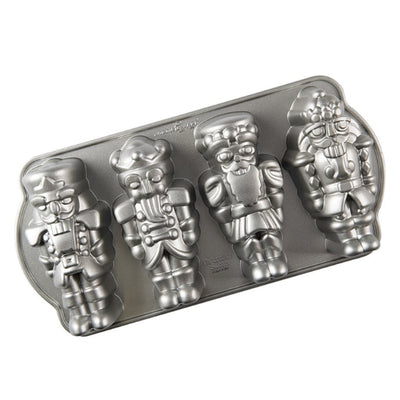 Metal cake pan with nutcracker-shaped cavities on a white background