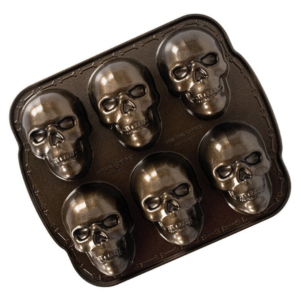 Skull-shaped baking mold on a white background